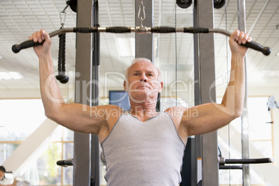 Man Weight Training At Gym