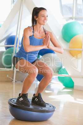 Woman Using On Balance Trainer At Gym