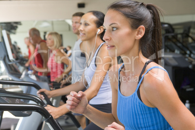 Woman Running On Treadmill At Gym