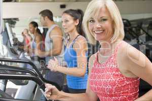 Woman Running On Treadmill At Gym