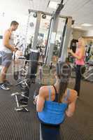 Group Of People Weight Training At Gym