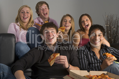 Teenagers Having Fun And Eating Pizza