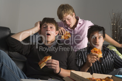 Teenage Boys Eating Pizza