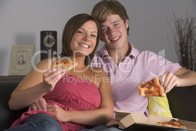 Teenage Couple Enjoying Pizza