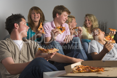 Teenagers Having Fun And Eating Pizza