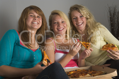 Teenage Girls Eating Pizza