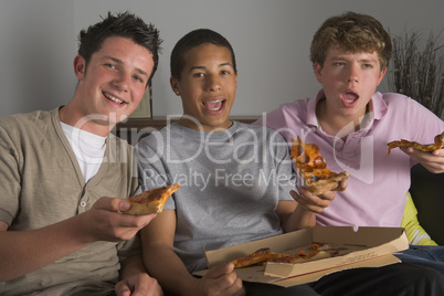 Teenage Boys Enjoying Pizza
