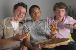 Teenage Boys Enjoying Pizza
