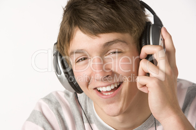 Teenage Boy Listening To Music On Headphones