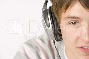 Teenage Boy Listening To Music On Headphones