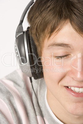 Teenage Boy Listening To Music On Headphones