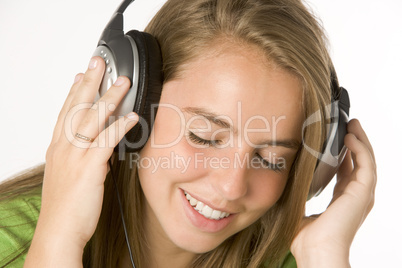 Teenage Girl Listening To Music On Headphones