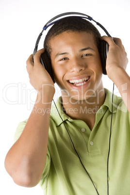 Teenage Boy Listening To Music On Headphones