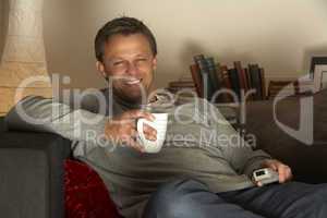 Man Relaxing With Coffee And Television