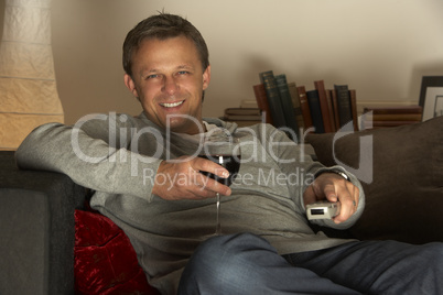 Man With Glass Of Wine Watching Television