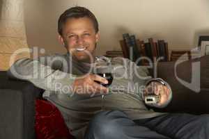 Man With Glass Of Wine Watching Television