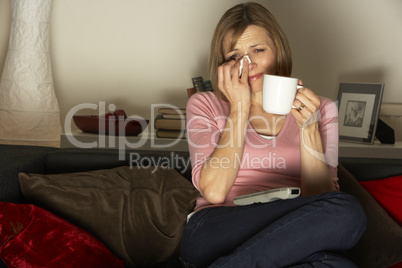 Woman Relaxing With Cup Of Coffee Watching Television