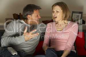 Couple Discussing Choice Of Television Channel