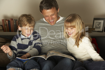 Father And Two Children Reading