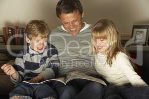 Father And Two Children Reading