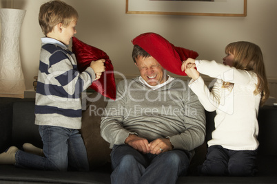 Father And Two Children In Pillow Fight