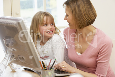 Woman And Daughter Using Computer