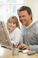 Father And Daughter Using Computer