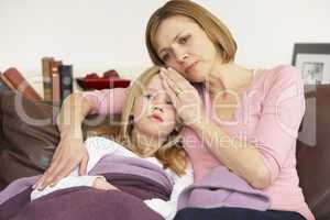 Mother Taking Temperature Of Sick Daughter