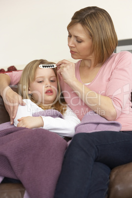 Mother Taking Temperature Of Sick Daughter