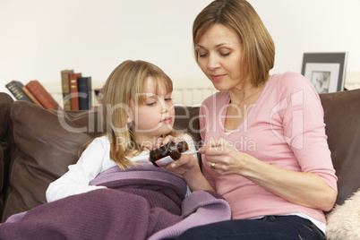 Mother Giving Medicine To Sick Daughter