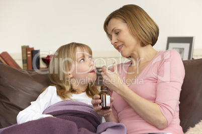 Mother Giving Medicine To Sick Daughter