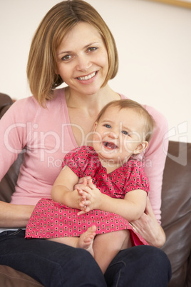 Mother And Baby Daughter On Sofa