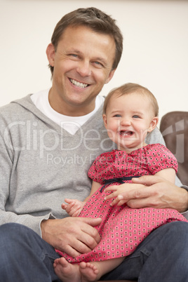 Father And Baby Daughter On Sofa