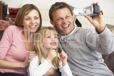 Parents And Daughter With Video Camera