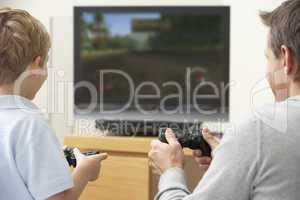 Father And Young Son Playing With Game Console