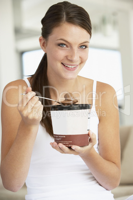 Eine junge Frau hält einen großen Becher Schokoeis