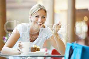 Woman Eating A Piece Of Cake At The Mall
