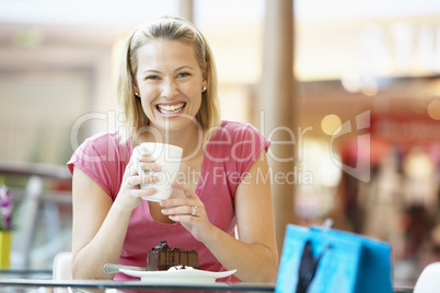 Woman Eating A Piece Of Cake At The Mall