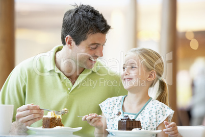 Father And Daughter Having Lunch Together At The Mall