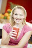 Woman Drinking A Berry Smoothie