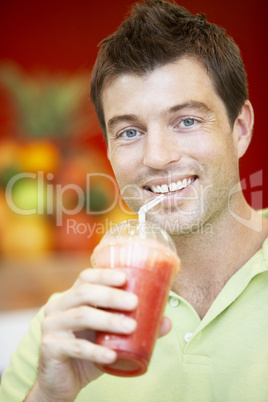 Man Drinking A Berry Smoothie