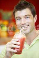 Man Drinking A Berry Smoothie