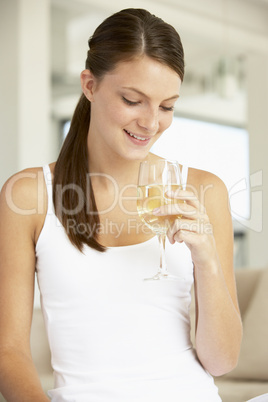 Young Woman Enjoying A Glass Of White Wine