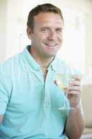 Man Enjoying A Glass Of White Wine