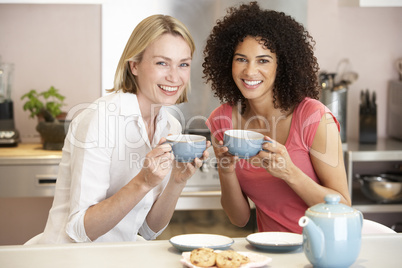 Female Friends Enjoying Tea And Cookies At Home