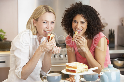 Female Friends Enjoying Tea And Cake At Home