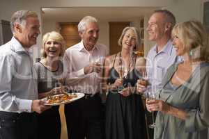 Man Serving Hors D'oeuvres To His Guests At A Dinner Party