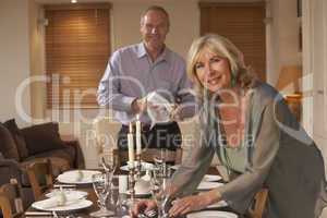 Couple Preparing Table For A Dinner Party