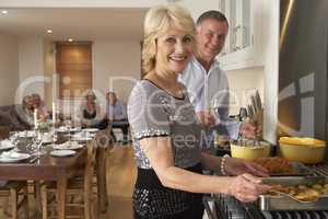 Couple Preparing Food For A Dinner Party