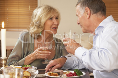 Couple Enjoying A Meal At Home Together